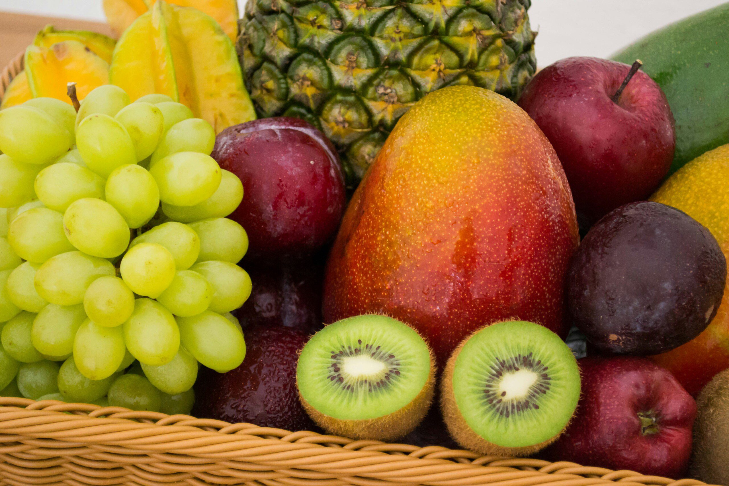 Colorful assortment of fresh fruits in a basket.