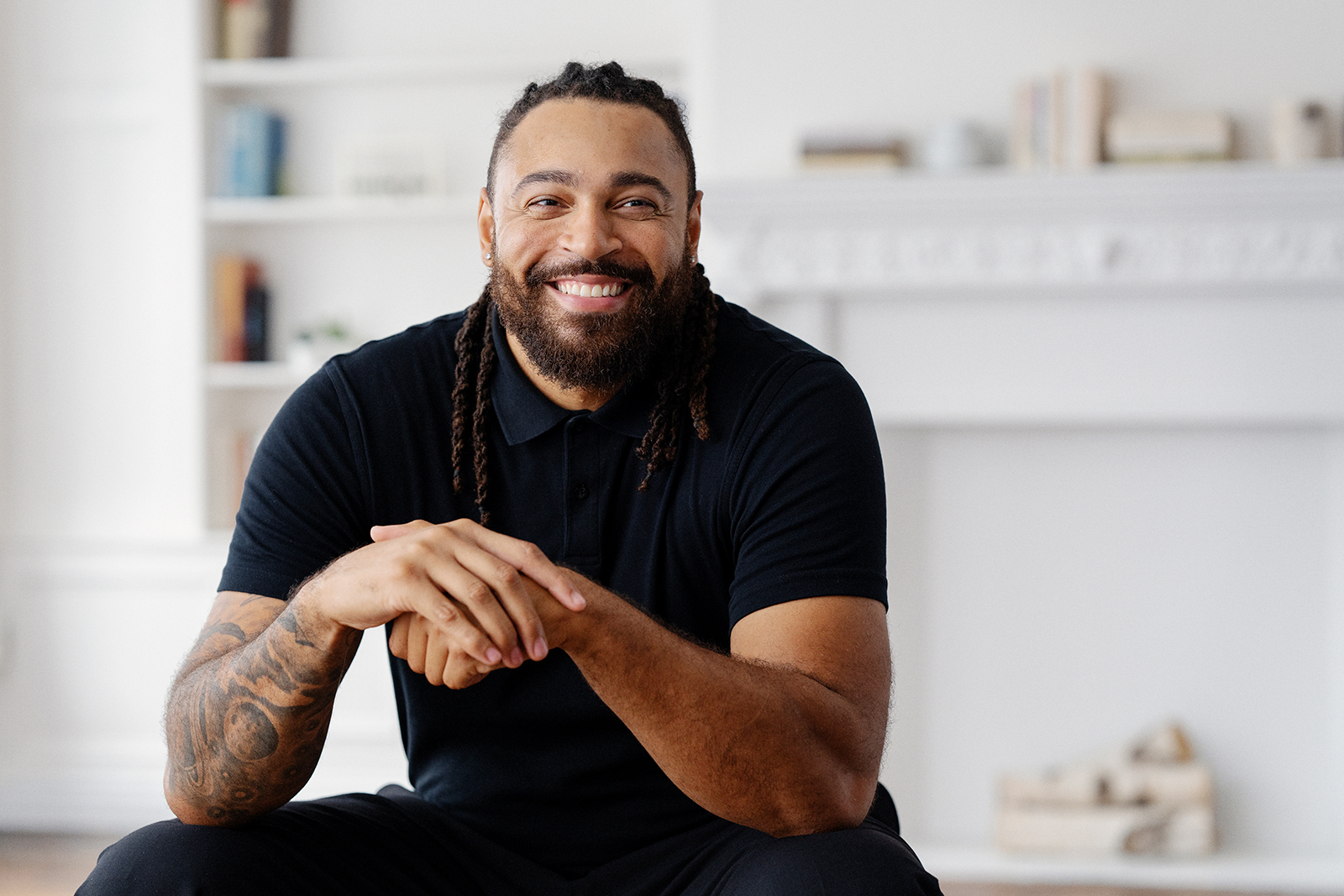 Smiling man with beard in a casual setting.