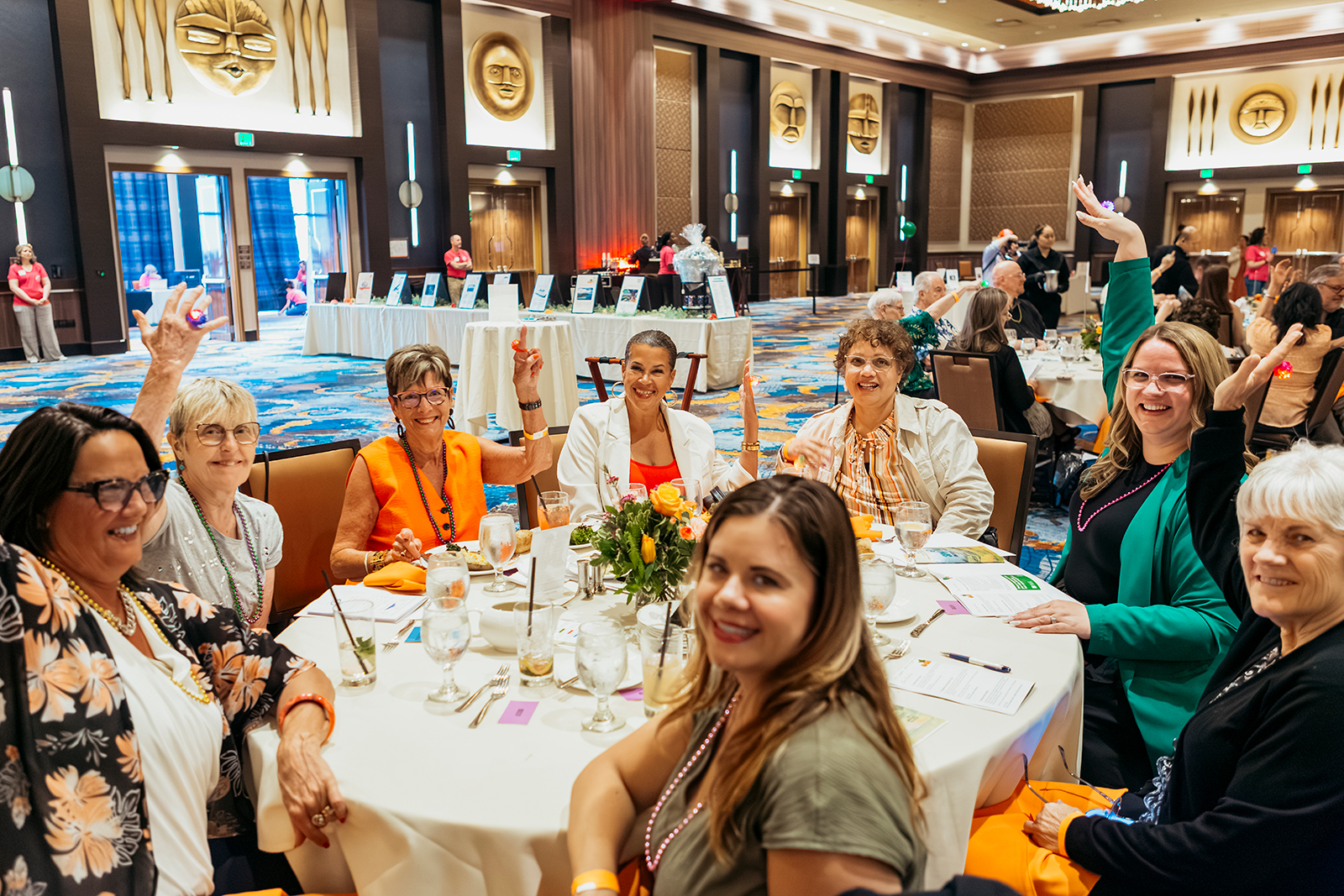 Women enjoying a festive gathering at a round table.