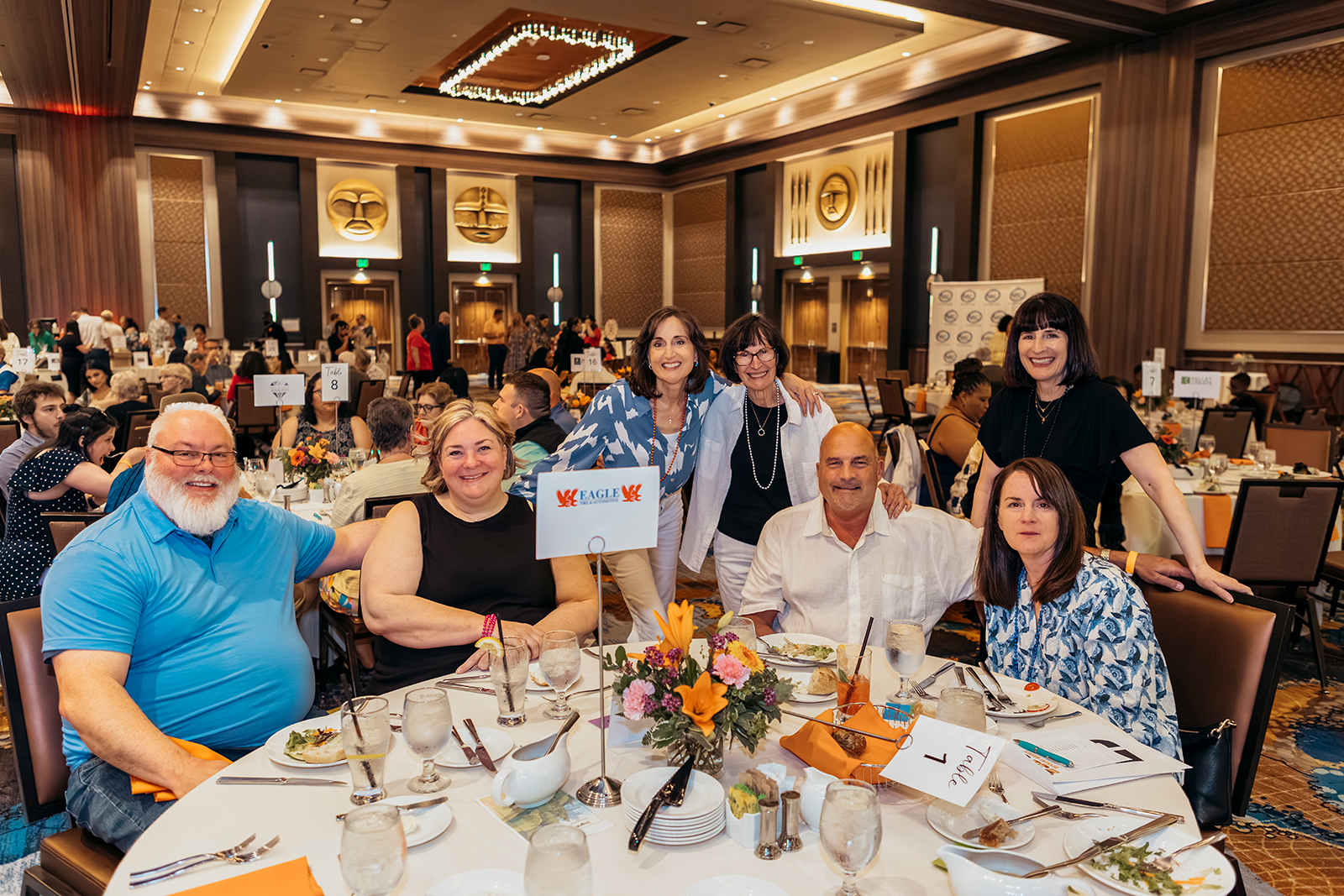 Group of people at a festive dining table event.