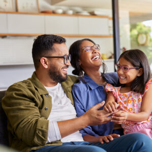 Happy family enjoying moments together on a sofa.