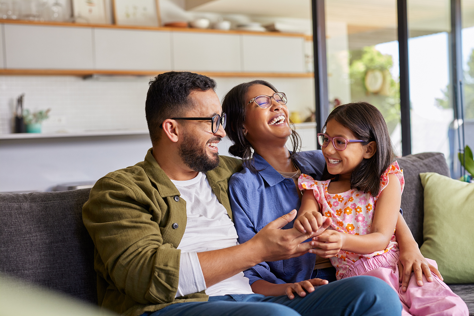Happy family enjoying moments together on a sofa.