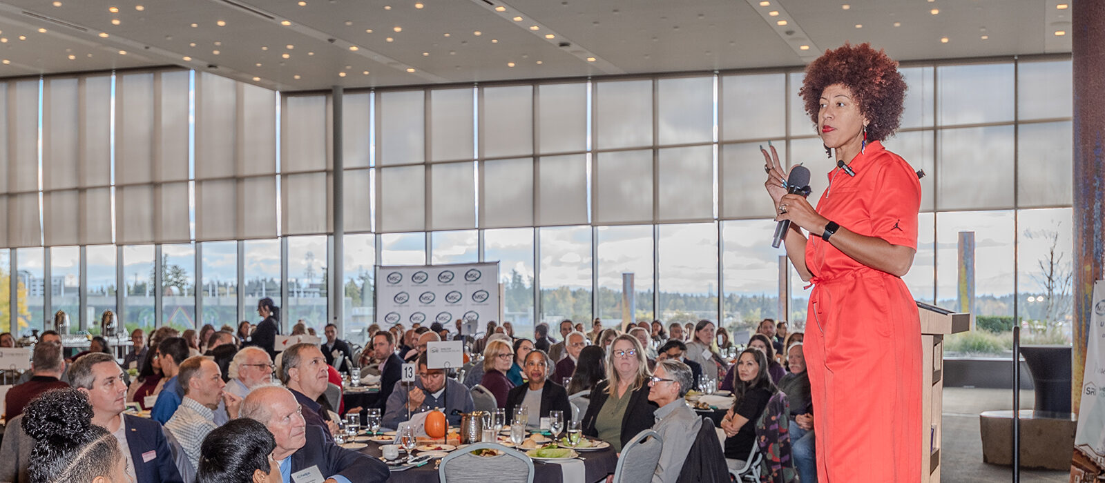 Speaker addressing an audience at a corporate event.