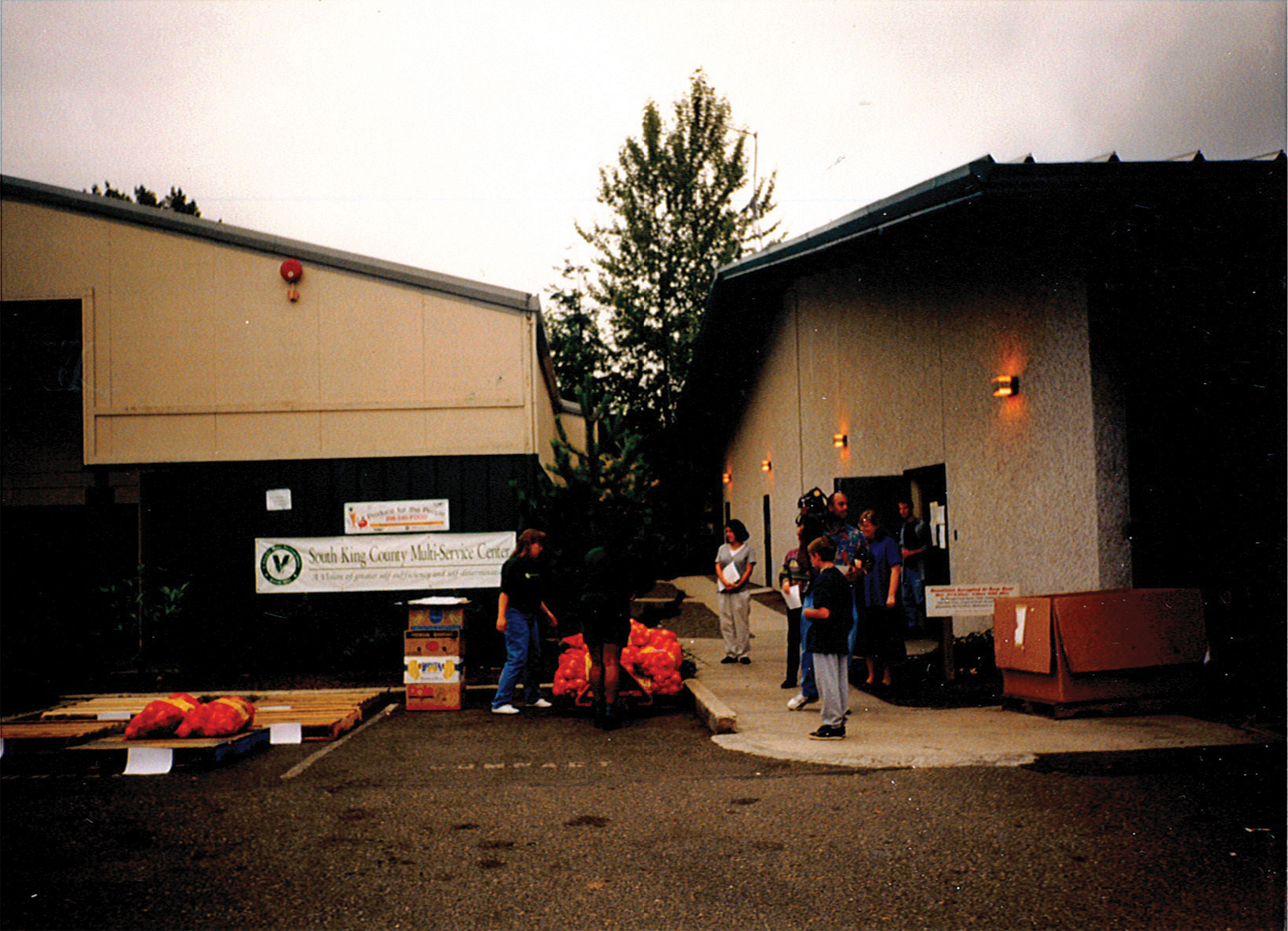 People gathered outside a multi-service center building.